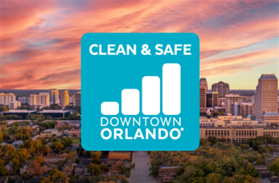 Downtown Orlando skyline at sunset with a blue logo on top for the Downtown Orlando Clean and Safe app