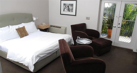 Hotel room with king size bed and 2 chairs. 