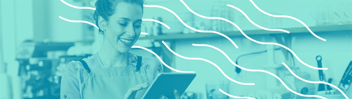 Person wearing an apron and holding a tablet in a workspace with shelves and equipment in the background. The image is overlaid with a teal color and white wavy graphic lines.